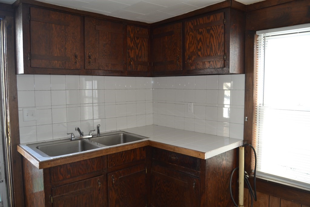 8 Cedar Court Lowell, MA 01852 - Photo 14 of 28 a bathroom with a sink and cabinets