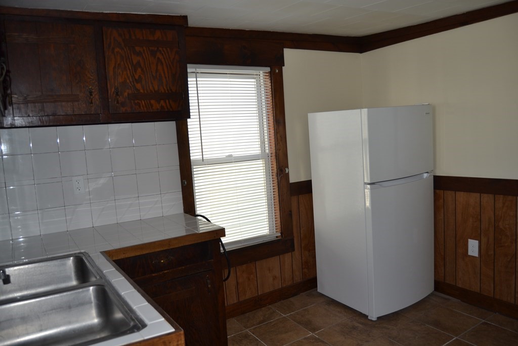 8 Cedar Court Lowell, MA 01852 - Photo 15 of 28 a refrigerator freezer sitting inside of a kitchen