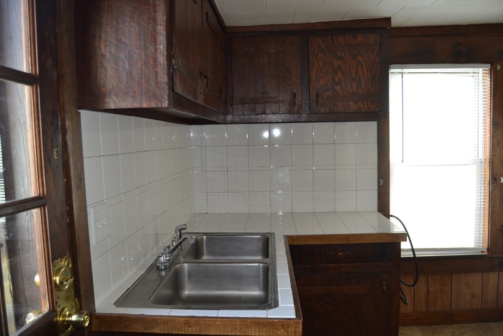 8 Cedar Court Lowell, MA 01852 - Photo 16 of 28 a sink with wooden cabinets