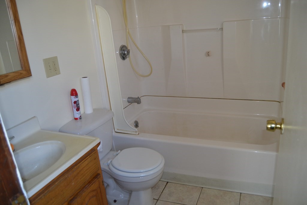 8 Cedar Court Lowell, MA 01852 - Photo 19 of 28 a bathroom with a sink a toilet and shower