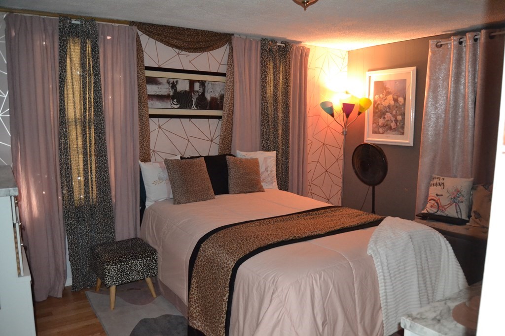 8 Cedar Court Lowell, MA 01852 - Photo 21 of 28 a bedroom with a bed toilet and a large mirror