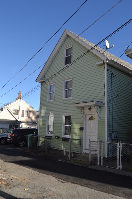 8 Cedar Court Lowell, MA 01852 - Photo 3 of 28 a front view of a house with a yard
