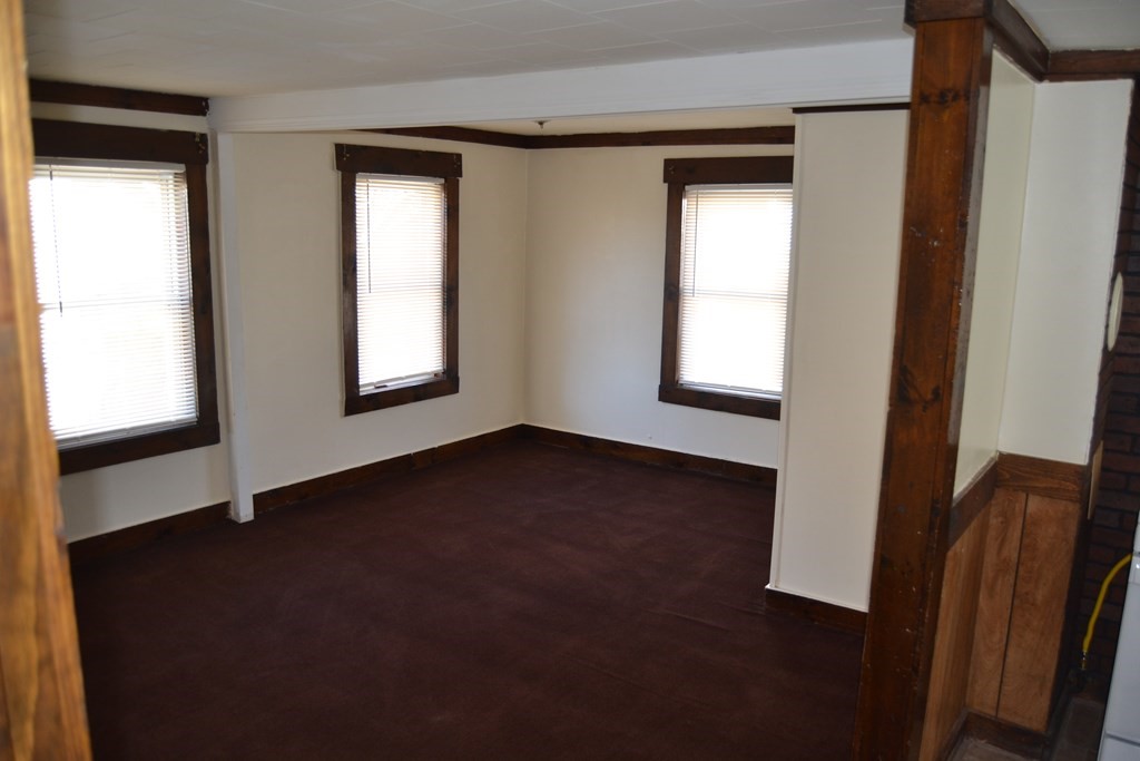 8 Cedar Court Lowell, MA 01852 - Photo 9 of 28 a view of an empty room with wooden floor and a window