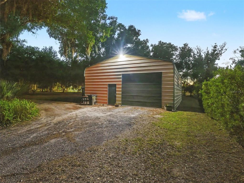 339 Corbett Road Lithia, FL 33547 - Photo 35 of 38 a front view of a house with a yard and garage