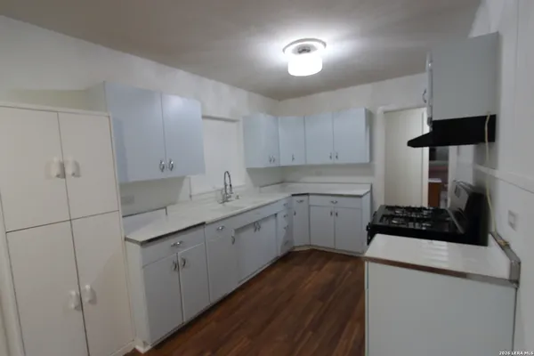 a kitchen with cabinets a sink and appliances