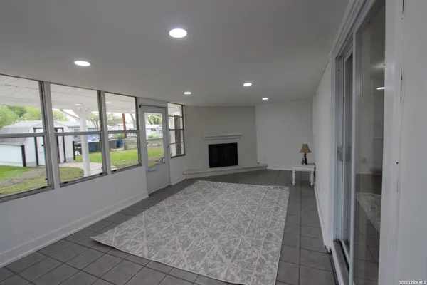 a view of hallway with a large window and chandelier