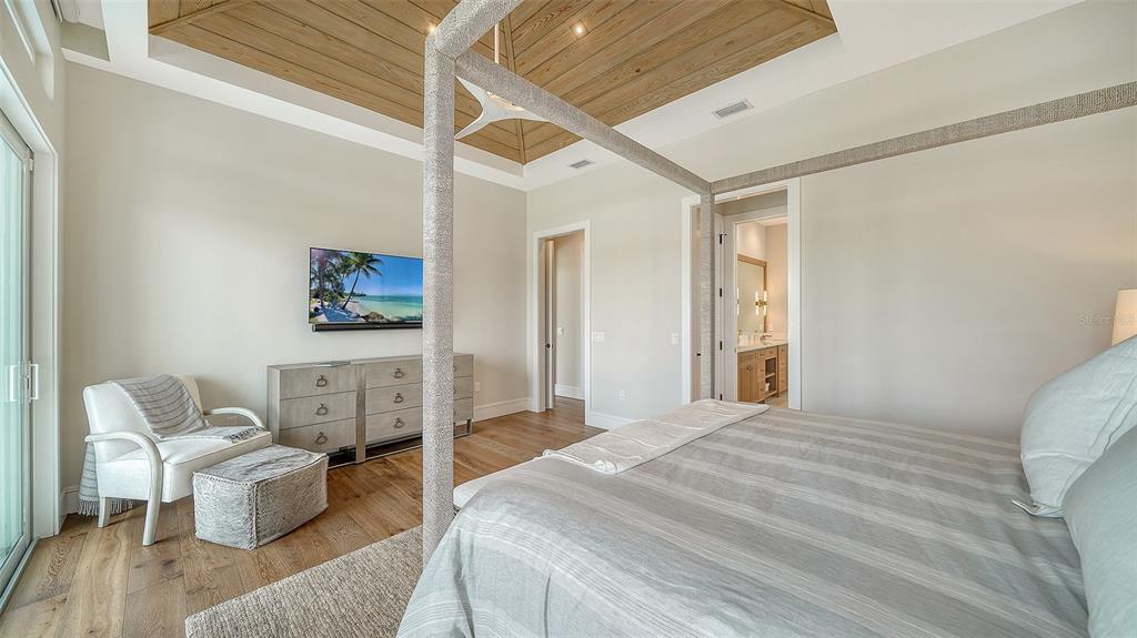 681 Old Compass Road Longboat Key, FL 34228 - Photo 20 of 67 a bedroom with a bed couch and a window