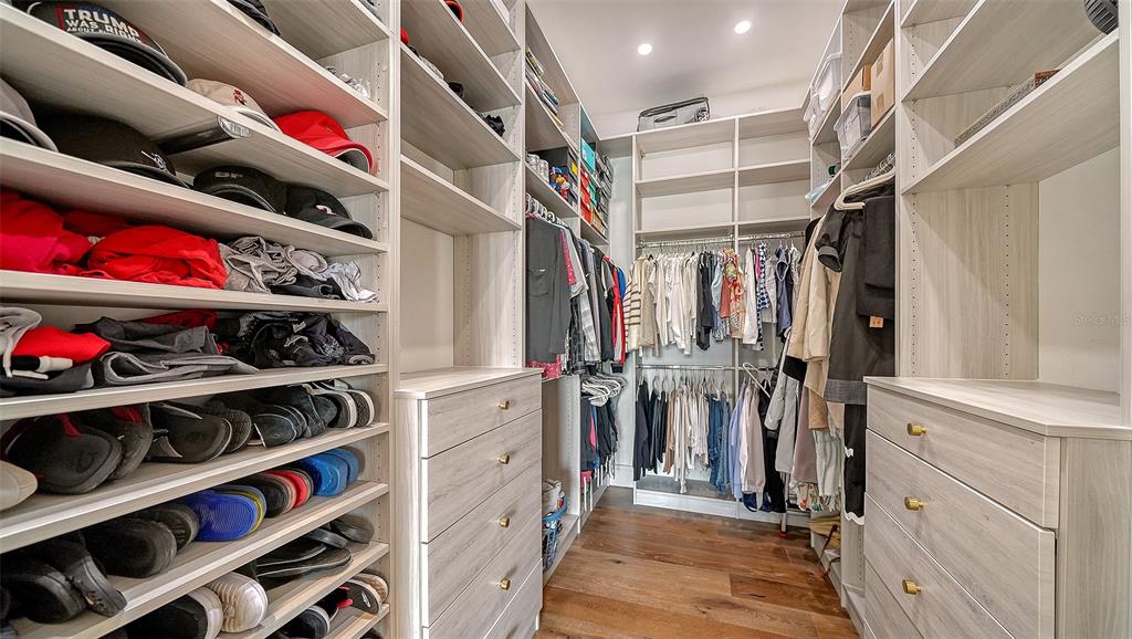 681 Old Compass Road Longboat Key, FL 34228 - Photo 21 of 67 a view of walk in closet with clothes and shoes