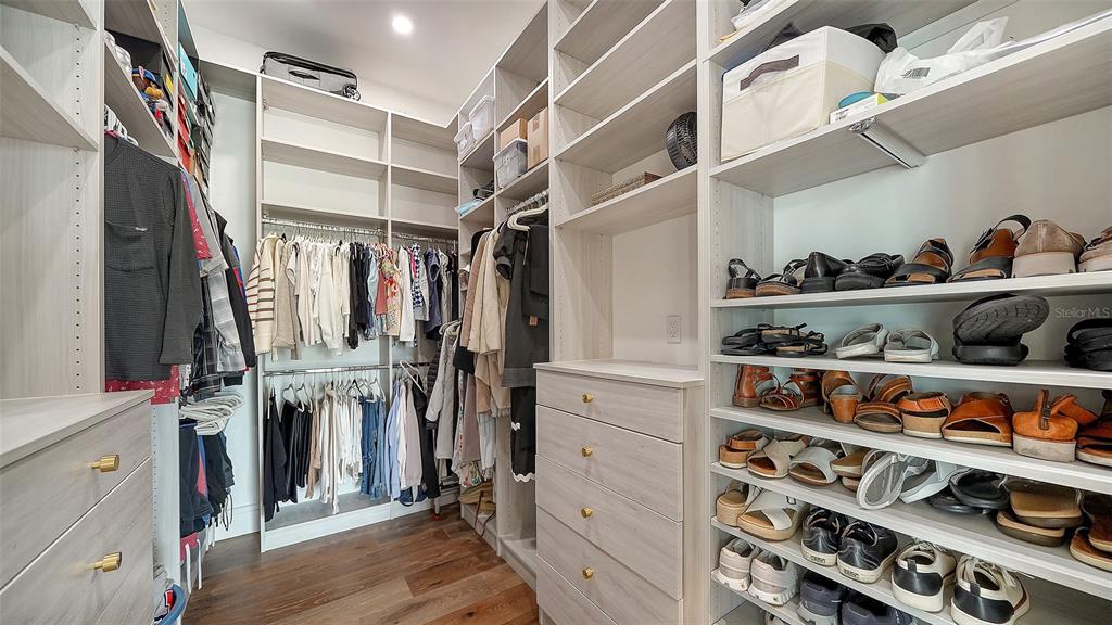 681 Old Compass Road Longboat Key, FL 34228 - Photo 22 of 67 a view of walk in closet with clothes and shoes