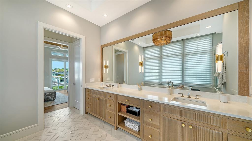 681 Old Compass Road Longboat Key, FL 34228 - Photo 24 of 67 a bathroom with a double vanity sink mirror and double