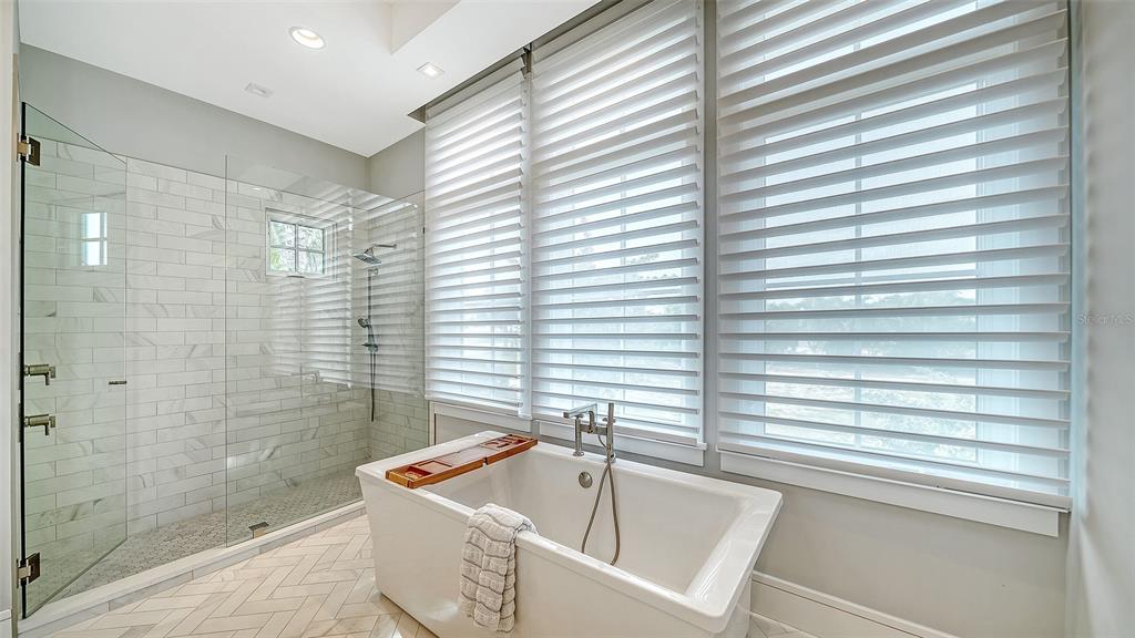 681 Old Compass Road Longboat Key, FL 34228 - Photo 25 of 67 a bathroom with a tub and a shower
