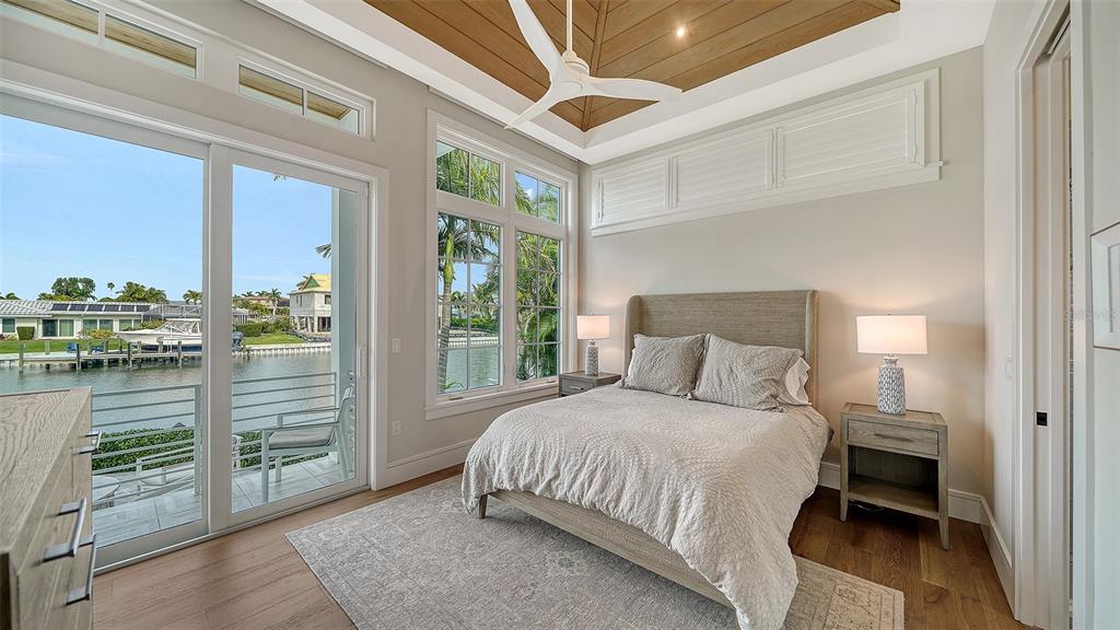 681 Old Compass Road Longboat Key, FL 34228 - Photo 30 of 67 a bedroom with a bed and a cabinets