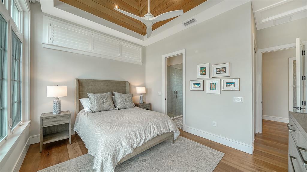 681 Old Compass Road Longboat Key, FL 34228 - Photo 31 of 67 a bedroom with a bed and wooden floor