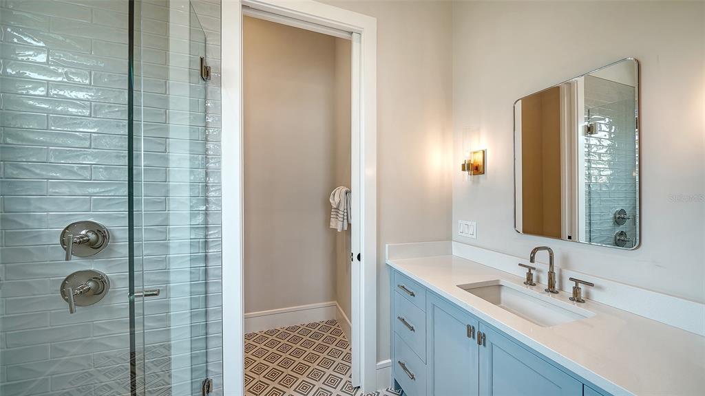 681 Old Compass Road Longboat Key, FL 34228 - Photo 32 of 67 a bathroom with a shower sink and mirror