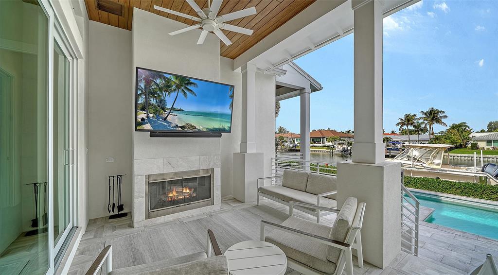 681 Old Compass Road Longboat Key, FL 34228 - Photo 47 of 67 a living room with furniture a fireplace and a flat screen tv