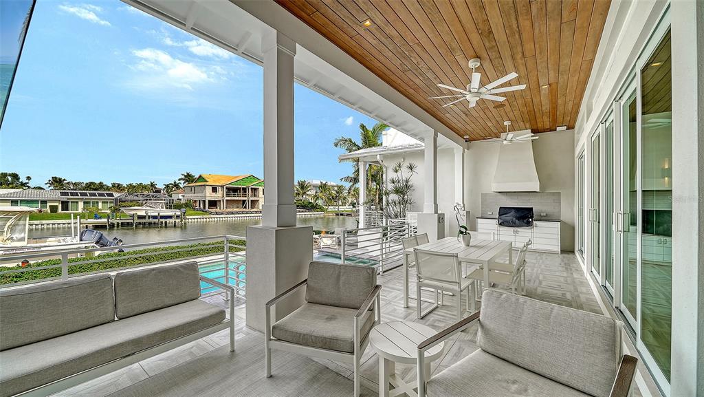 681 Old Compass Road Longboat Key, FL 34228 - Photo 48 of 67 a dining room with furniture and a large window