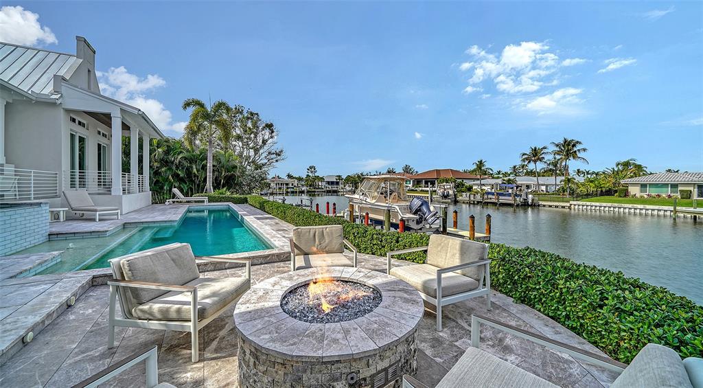 681 Old Compass Road Longboat Key, FL 34228 - Photo 55 of 67 a view of a chair and tables in the patio