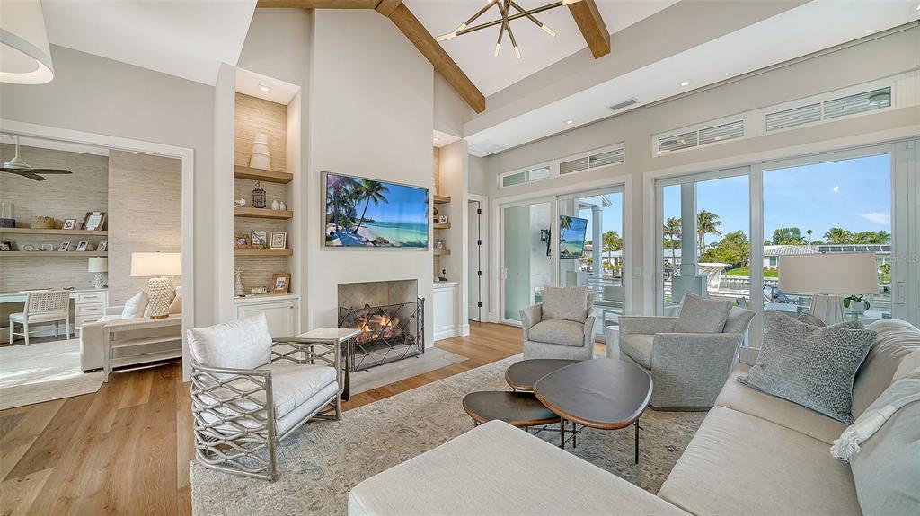 681 Old Compass Road Longboat Key, FL 34228 - Photo 8 of 67 a living room with furniture and a fireplace