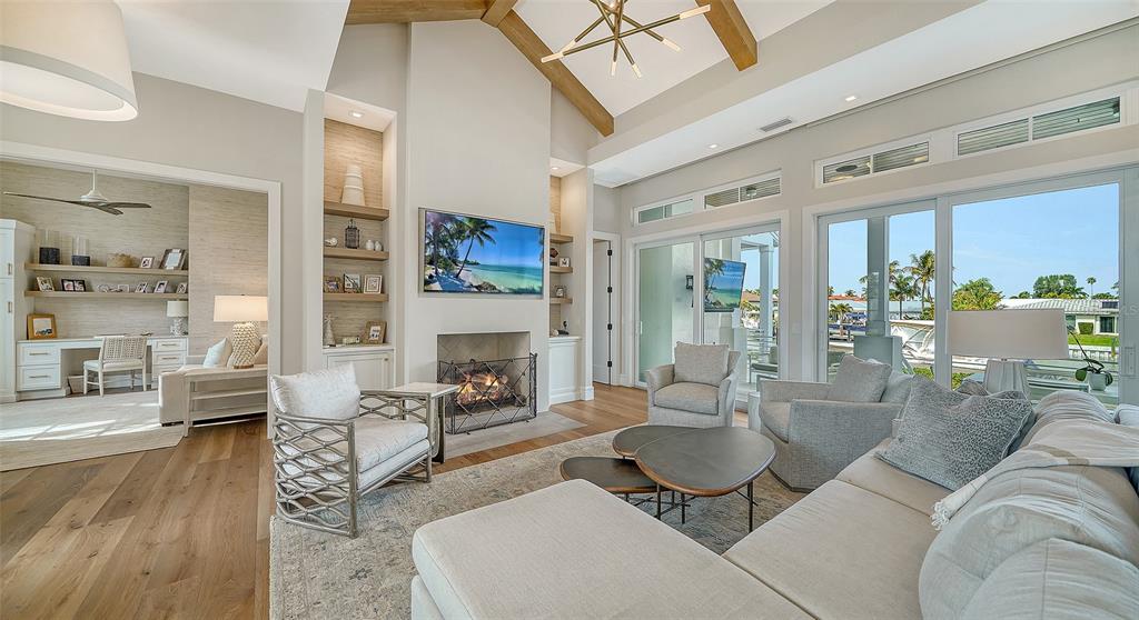 681 Old Compass Road Longboat Key, FL 34228 - Photo 9 of 67 a living room with furniture and a fireplace