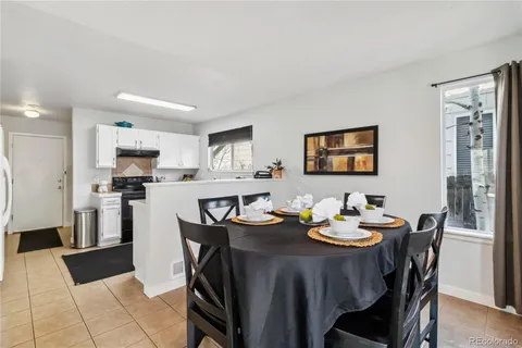 a view of a dining room with furniture and a kitchen