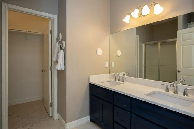 a bathroom with a double vanity sink and a mirror