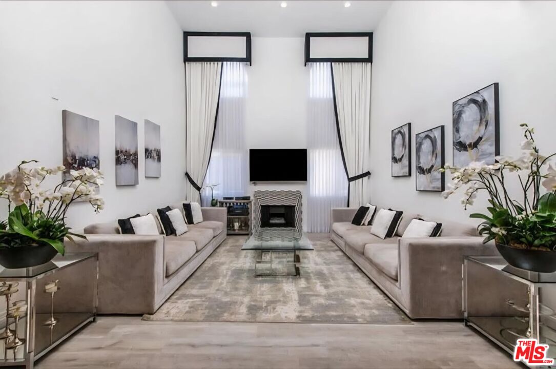 1227 Granville Avenue, Unit PH2 Los Angeles, CA 90025 - Photo 1 of 2 a living room with fireplace furniture and a flat screen tv