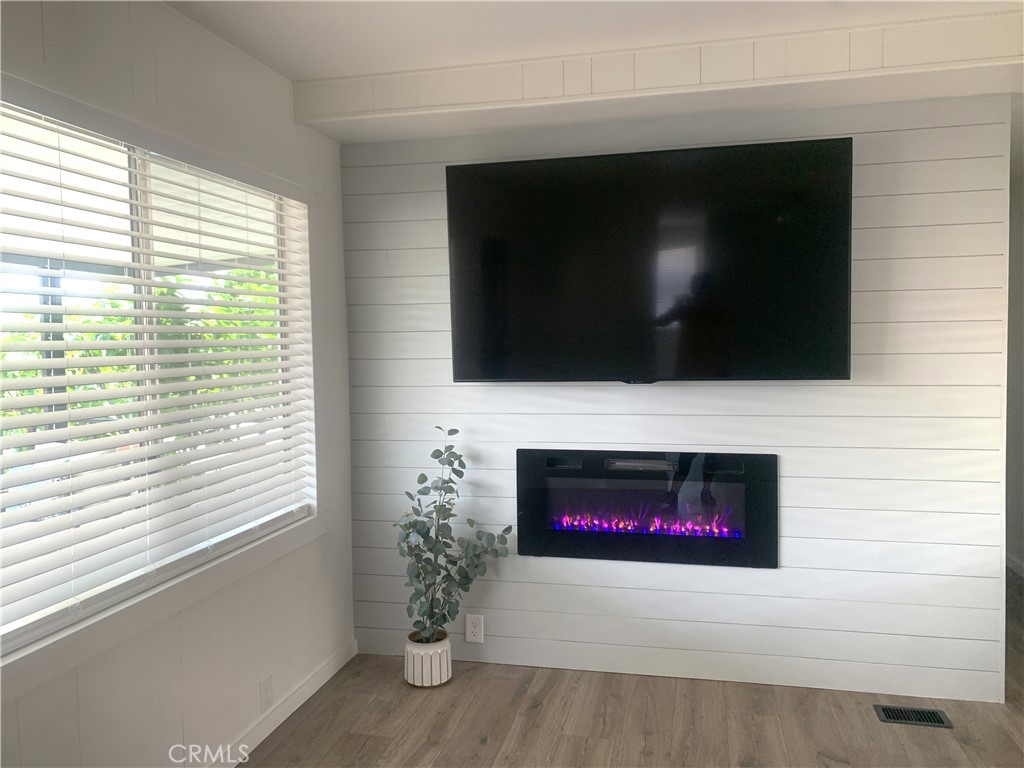 975 California Street, Unit 72 Calimesa, CA 92320 - Photo 9 of 23 a living room with a flat screen tv and a fireplace