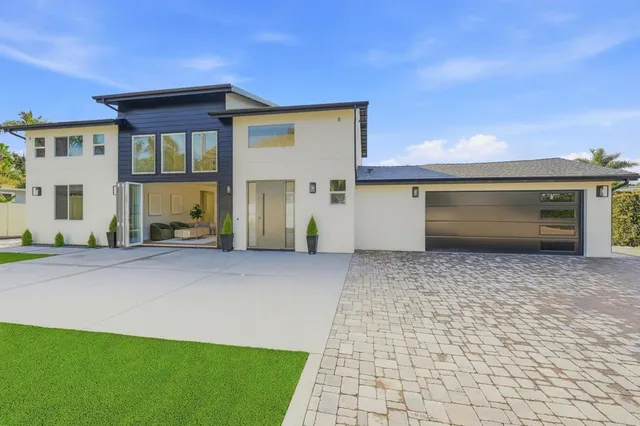 a aerial view of a house with a yard and potted plants