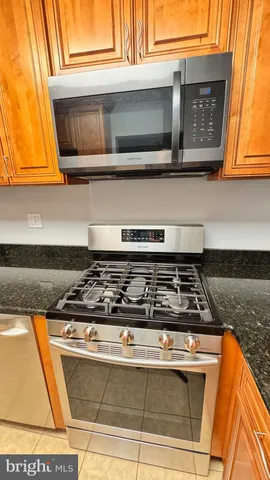 a stove top oven sitting inside of a kitchen