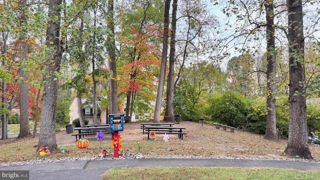 a backyard of a house with trees and outdoor seating