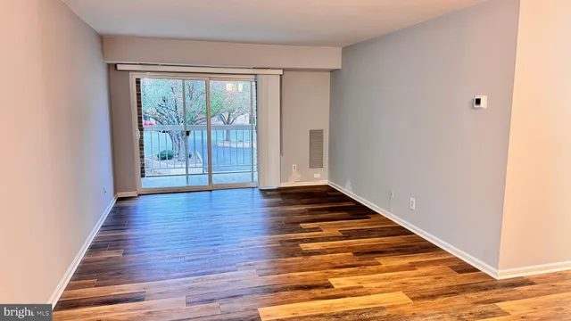 a view of wooden floor and windows in a room