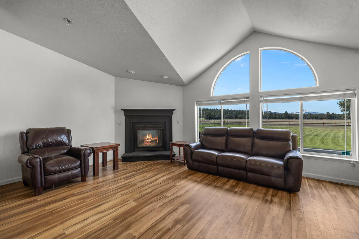 67500 Harrington Loop Road Bend, OR 97703 - Photo 15 of 72 a living room with furniture and a large window