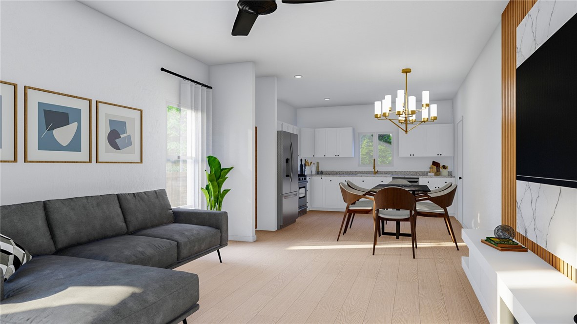 5024 Palisade Avenue Merced, CA 95348 - Photo 3 of 12 a living room with furniture a chandelier and a flat screen tv