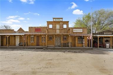 14433 Roy Rogers Ranch Road Oro Grande, CA 92368 - Photo 23 of 64 a front view of a house with a yard