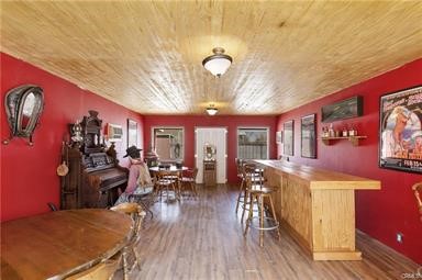 14433 Roy Rogers Ranch Road Oro Grande, CA 92368 - Photo 32 of 64 a view of a dining room with furniture a chandelier and wooden floor
