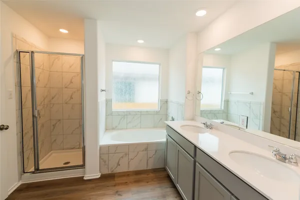 a bathroom with a double vanity sink mirror and shower
