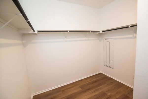 a view of walk in closet with empty racks
