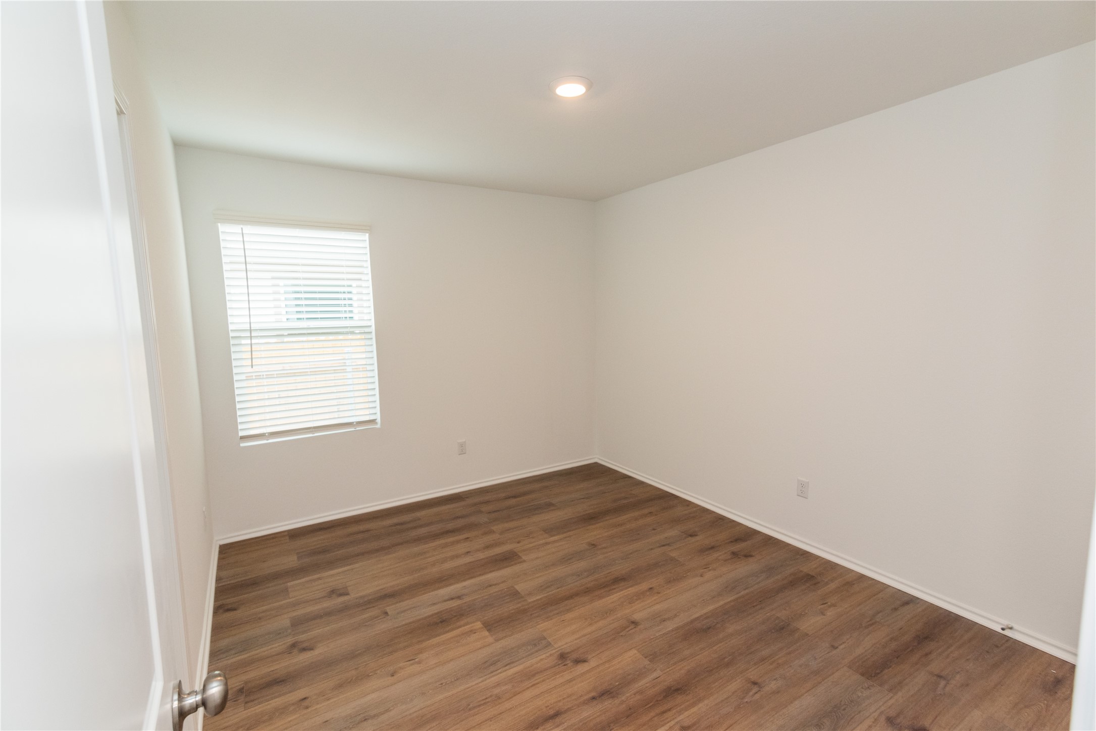 116 The Ugly Way Jarrell, TX 76537 - Photo 19 of 27 an empty room with wooden floor and windows