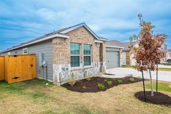 a view of a house with backyard and sitting area