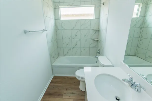 a bathroom with a sink a toilet and bathtub