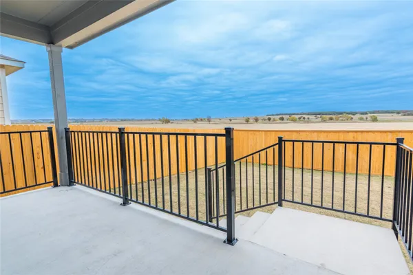 a view of a house with backyard and wooden fence