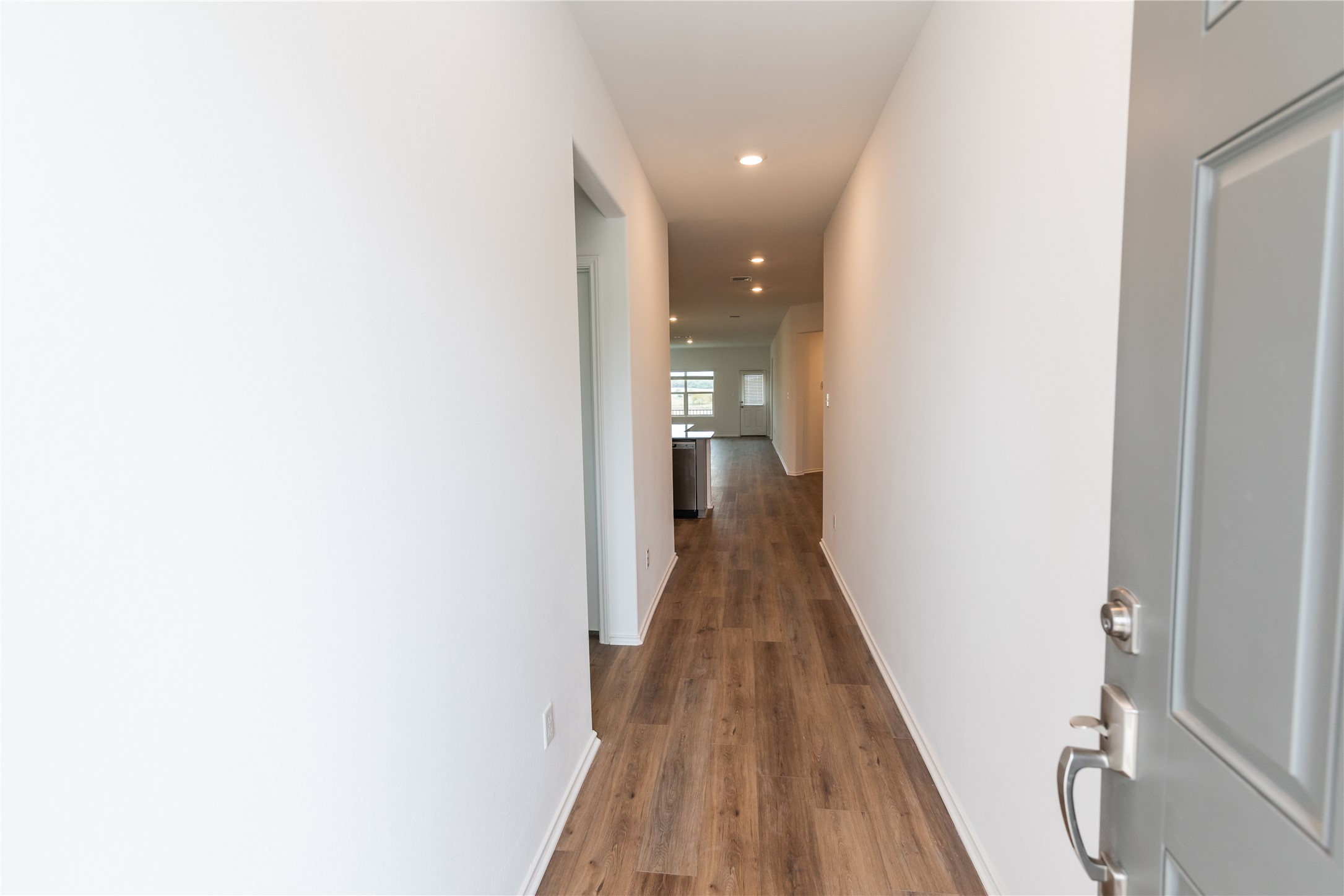 116 The Ugly Way Jarrell, TX 76537 - Photo 3 of 27 a view of a hallway with wooden floor and staircase