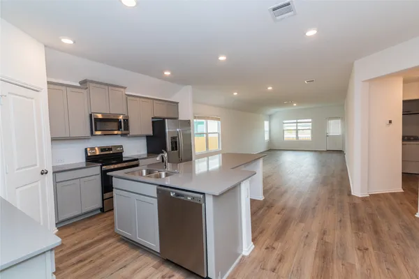 a kitchen with granite countertop a sink and steel appliances
