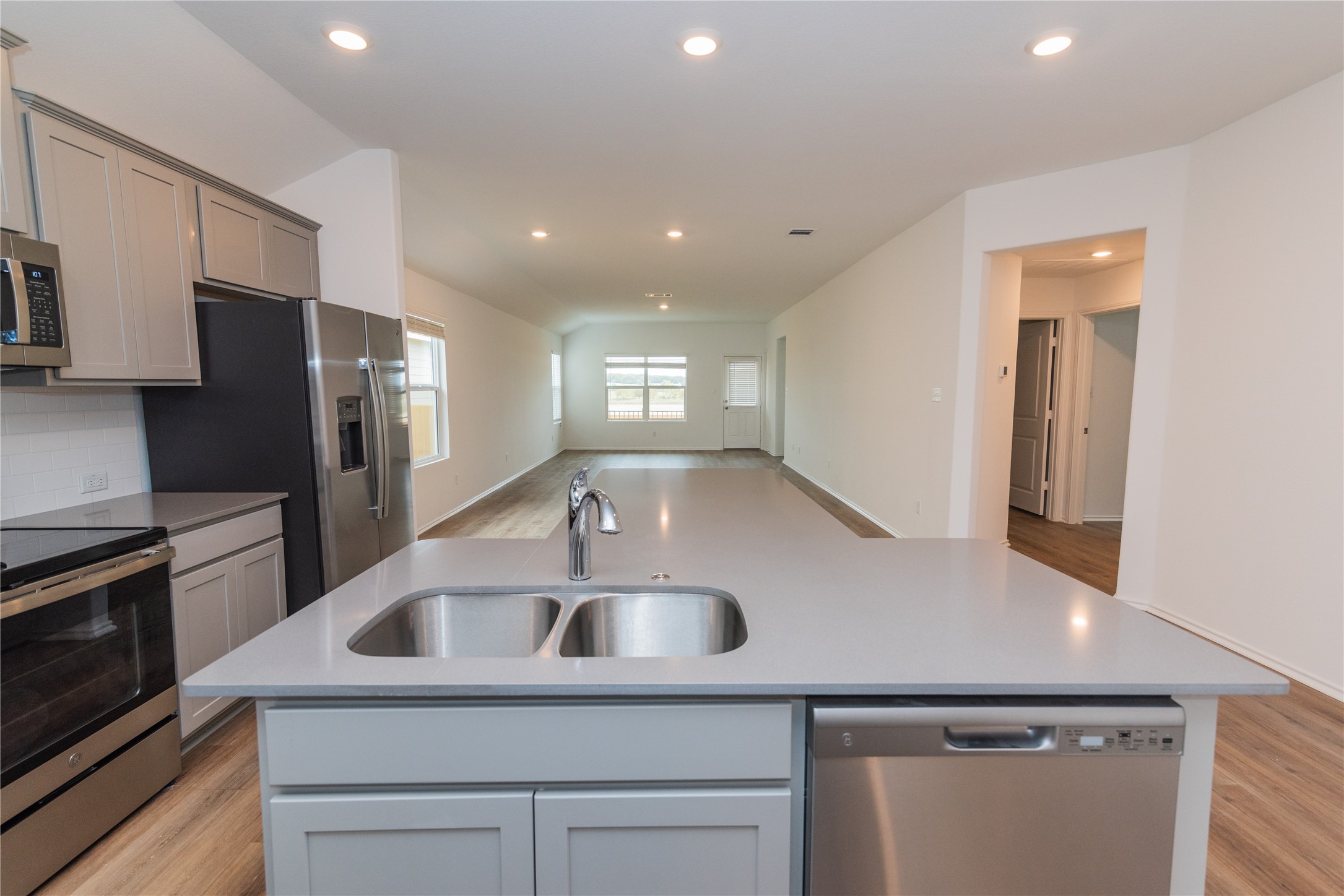 116 The Ugly Way Jarrell, TX 76537 - Photo 5 of 27 a kitchen with kitchen island a sink stainless steel appliances and cabinets