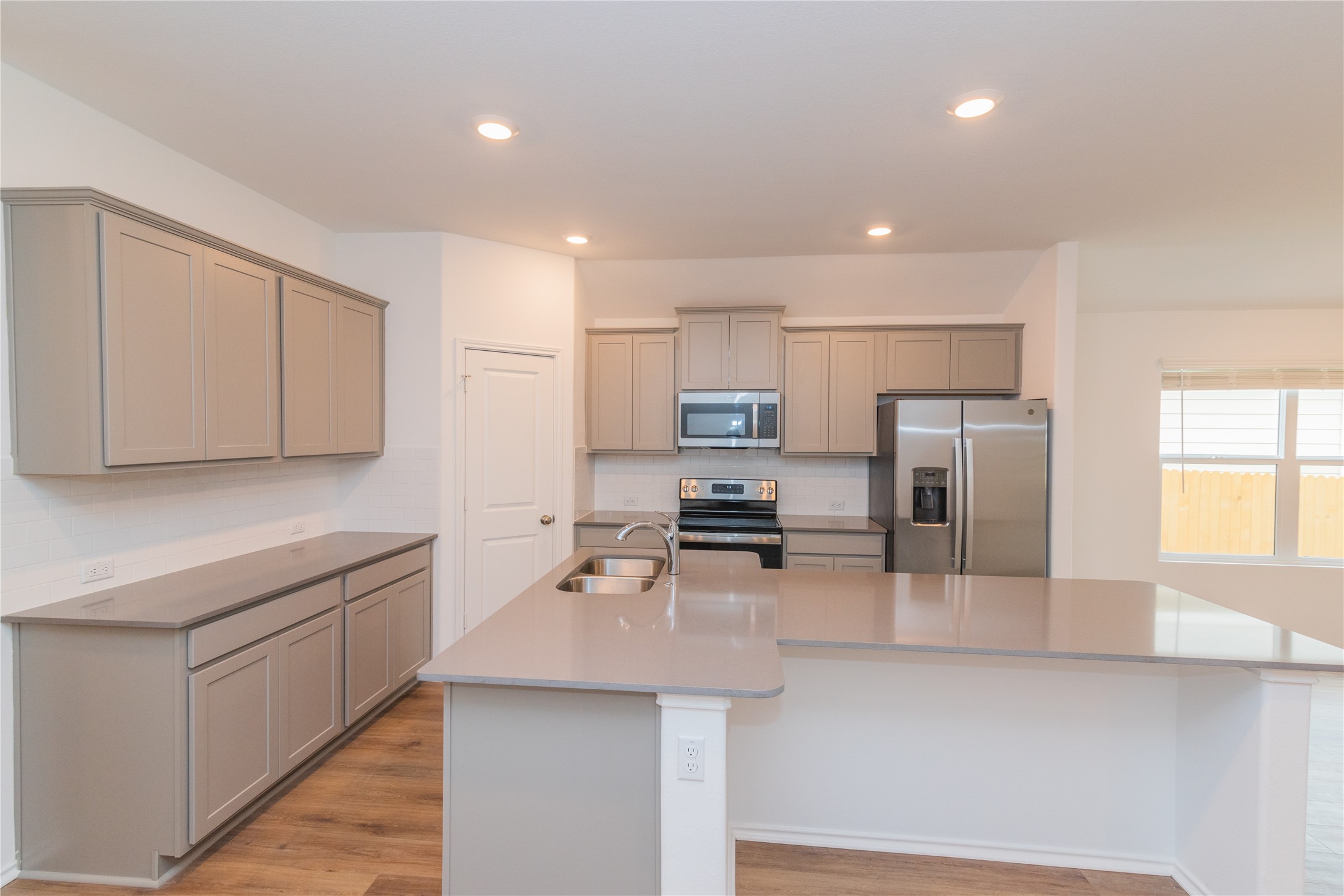 116 The Ugly Way Jarrell, TX 76537 - Photo 6 of 27 a kitchen with stainless steel appliances a sink counter space cabinets and a counter top space