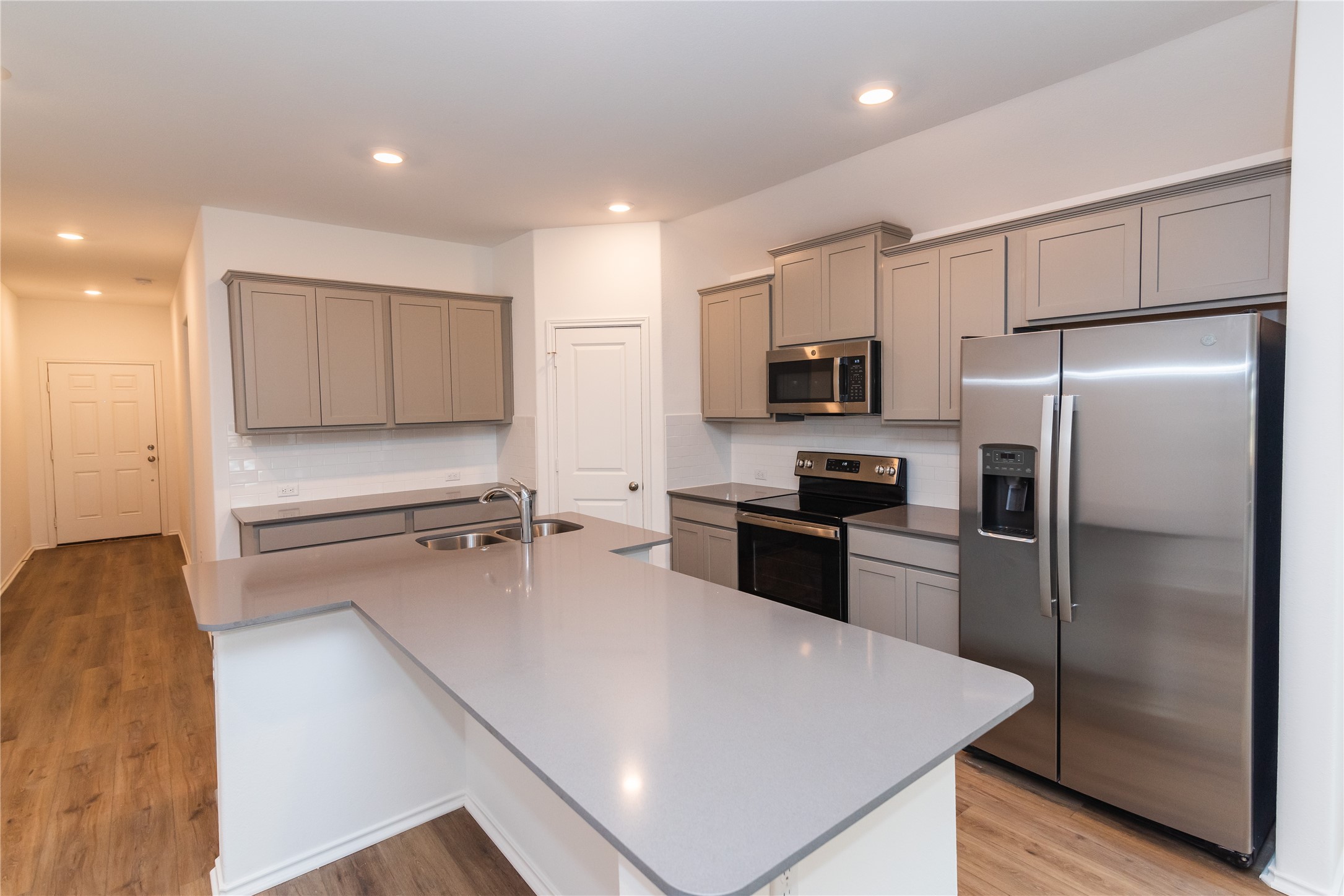 116 The Ugly Way Jarrell, TX 76537 - Photo 8 of 27 a kitchen with a refrigerator a stove top oven and a sink