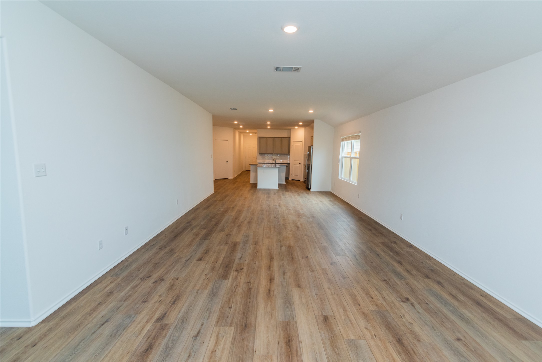 116 The Ugly Way Jarrell, TX 76537 - Photo 10 of 27 a view of empty room with wooden floor