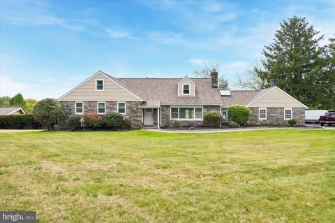a front view of a house with a big yard