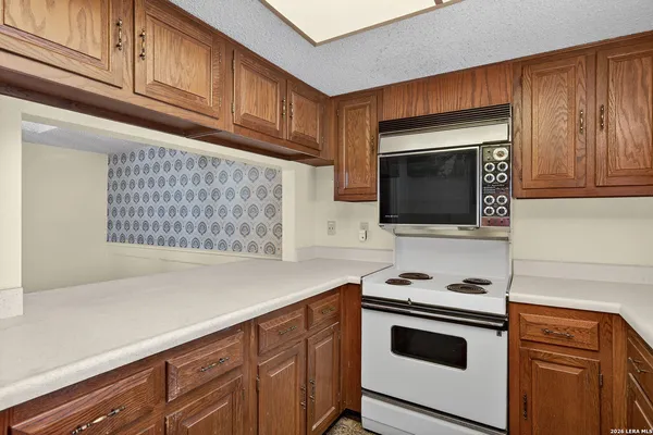 a kitchen with stainless steel appliances granite countertop a stove microwave and sink