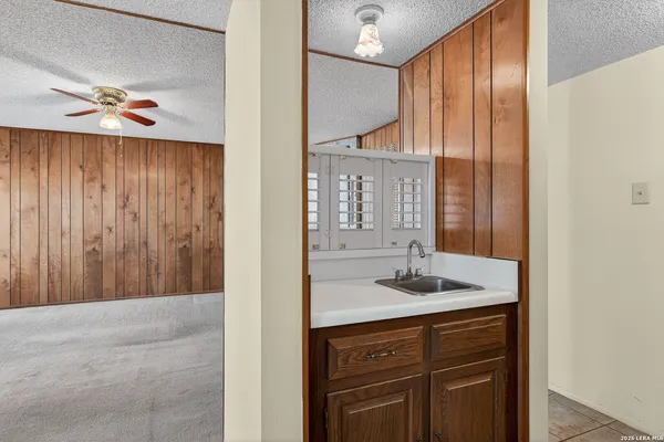 a bathroom with a granite countertop sink and a mirror